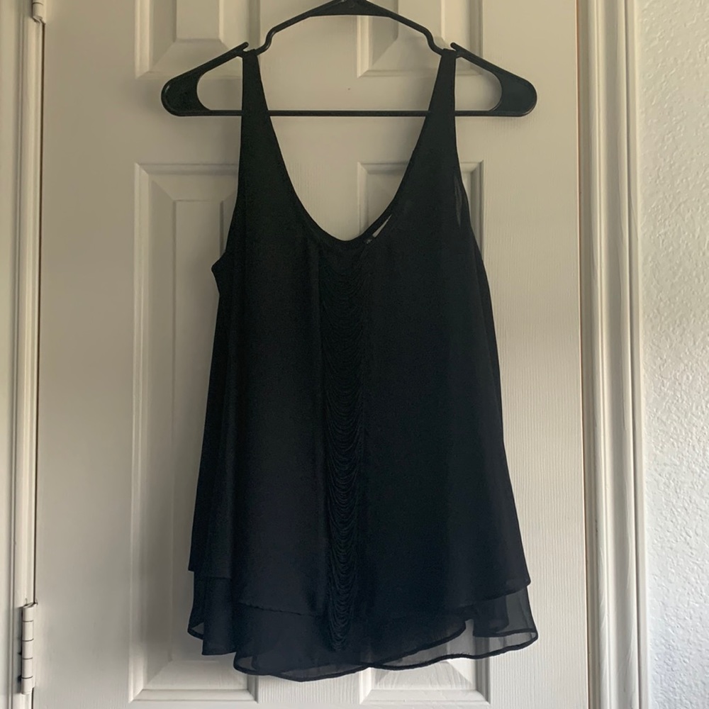 Flowy black tank top chiffon with fringe detail.